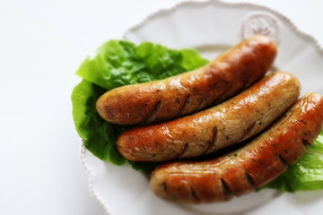 grilled pork sausage on lettuce with copy space