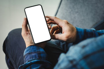 Mockup image blank white screen cell phone.man hand holding texting using mobile on desk at office.background empty space for advertise text.people contact marketing business,technology 
