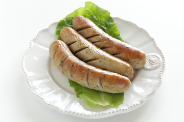 Grilled pork sausage on lettuce with copy space