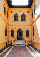 Yellow French Colonial building artisan window and door frame of Udon Thani city museum, Thailand