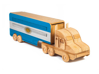 Close-up of a wooden toy truck with a painted national flag Argentina. The concept of export-import,transportation, national delivery of goods
