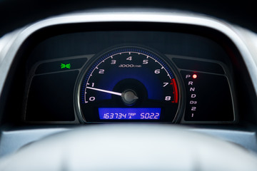 Close up Instrument automobile panel with Odometer, speedometer, tachometer, fuel level.