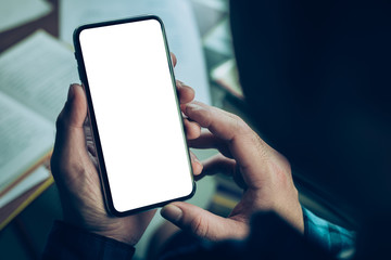 Mockup image blank white screen cell phone.man hand holding texting using mobile on desk at office.background empty space for advertise text.people contact marketing business,technology 