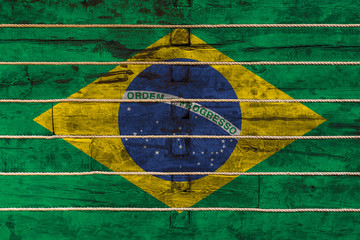 National flag  of Brazil on a wooden wall background. The concept of national pride and a symbol of...