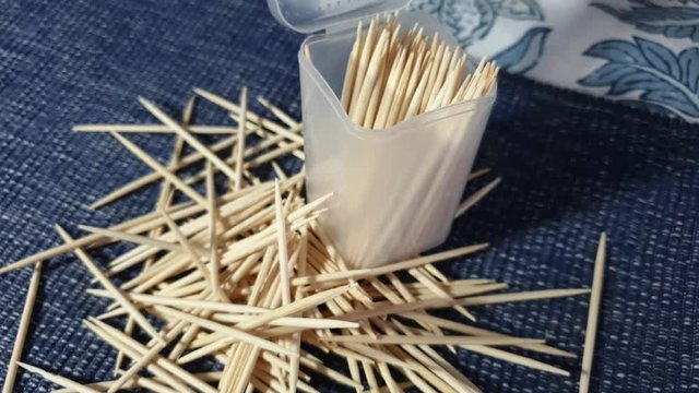 Not struggling to select one pointy wooden toothpick out of the case, just throw a bunch out on the table out of frustration with hand.