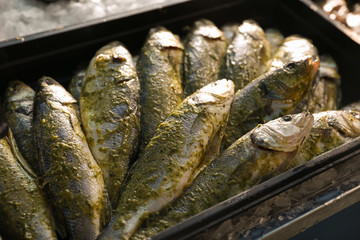 Fresh marinated fish in plastic container, closeup