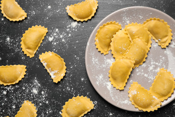Ravioli on grey wooden table, flat lay. Italian pasta