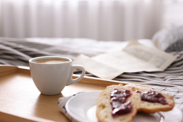 Morning coffee and sandwiches on tray in bedroom. Space for text