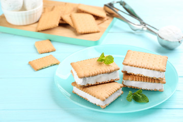 Fototapeta na wymiar Sweet delicious ice cream cookie sandwiches on light blue wooden table