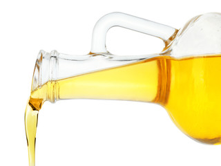 Pouring cooking oil from pitcher isolated on white