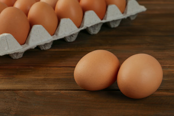 Raw brown chicken eggs on wooden table