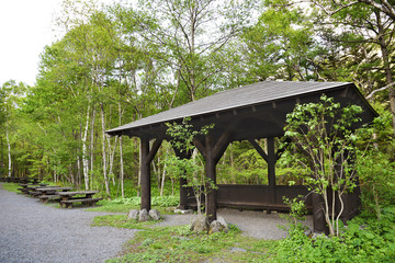 Wooden seat and pavilion on hiking trail in Hotaka mountain range, Kamikochi national park, Kamikochi, Japan