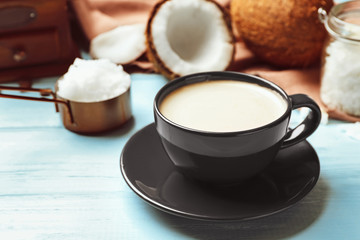 Delicious coffee with organic coconut oil on blue wooden table