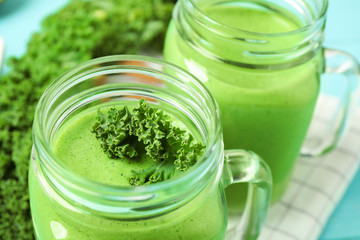 Tasty fresh kale smoothie on table, closeup