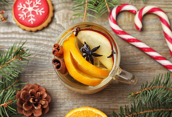 Aromatic mulled wine on wooden table, flat lay
