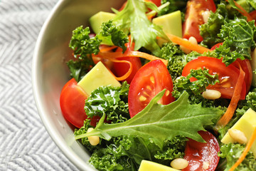 Tasty fresh kale salad on table, closeup