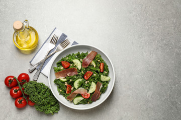 Delicious kale salad on light grey table, flat lay. Space for text