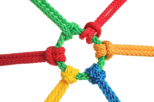 Colorful ropes tied together isolated on white. Unity concept