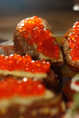 Sandwiches. Sliced rye loaf with salmon caviar and butter