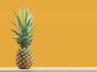 Pineapple with yellow background.