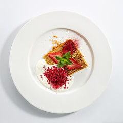 Traditional Russian Honey Cake Medovik on Restaurant Plate Isolated