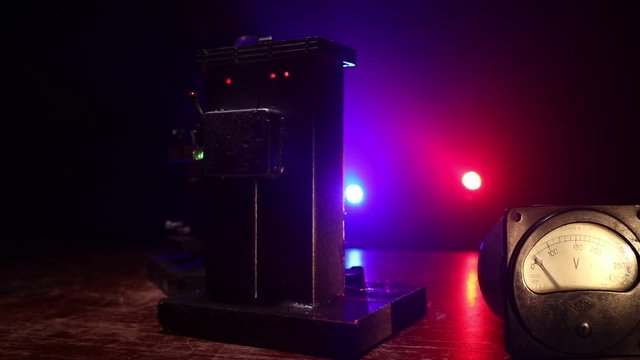 Death penalty electric chair miniature on dark. Creative artwork decoration. Image of an electric chair scale model on a dark backgorund