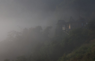 Fototapeta na wymiar House on roadside in a foggy day