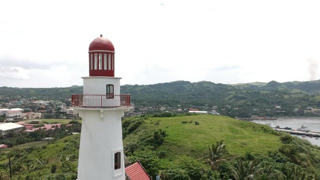 Close up of Batanes Basco lighthouse at the top of the hill