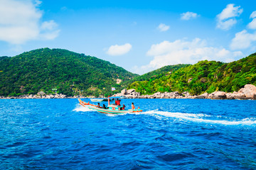 Seascape view with travelers enjoy sightseeing on Thai traditional wooden longtail boat at Koh Tao island, Thailand