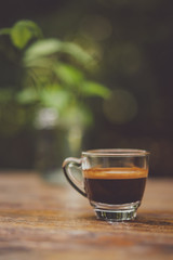 Espresso shot on wood table in cafe shop.