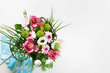 Flower bouquet with gift boxes on white background with copy space. Flat lay, top view. Valentine's Day or Mother's Day concept