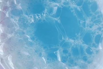blue soap foam macro background.soap bubbles blue pastel color with a white gradient. Detergent texture. Shower gel. Purity and freshness. Bath foam. Lightness and airiness	