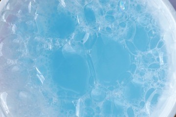 blue soap foam macro background.soap bubbles blue  color with a white gradient. Detergent texture....