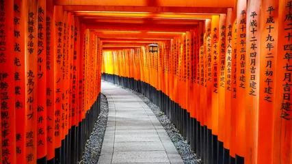 Fotobehang walking past torii gates and lantern at fushimi inari shrine © chris