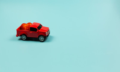  Valentines Day Theme Concept. Retro red toy car with red heart on mint background. Copy Space for text