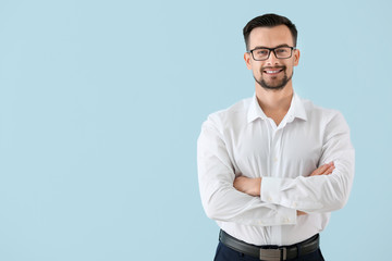Portrait of young businessman on color background