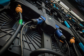 Detail of a rear portion of a LED LCD wall or stage panel. Display system for concerts, with visible rear panel with power and signal connectors visible.