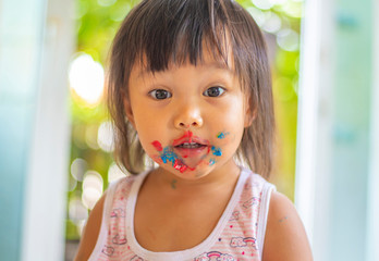 Face image of an Asian girl with a smile and fun.