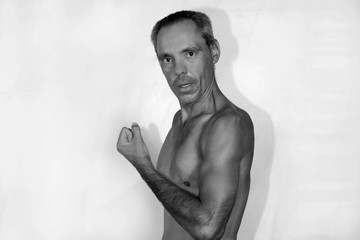 Black and white portrait of a nude man with autism that demonstrates his physical muscle strength