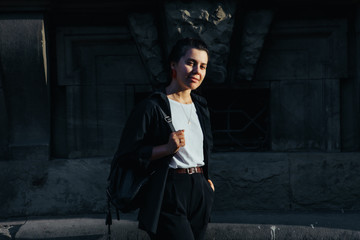 Naklejka premium portrait of young pretty woman at city street sunset light
