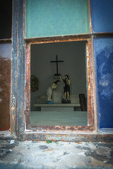 Broken Stained Glass Window With Rustic Catholic Figurines