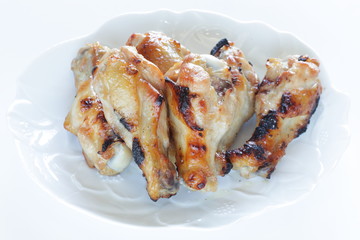 Asian chicken drumsticks barbecue on white dish