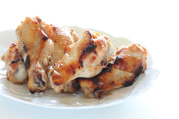 Asian chicken drumsticks barbecue on white dish