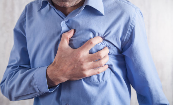Man touching his heart. Heart attack. Disease