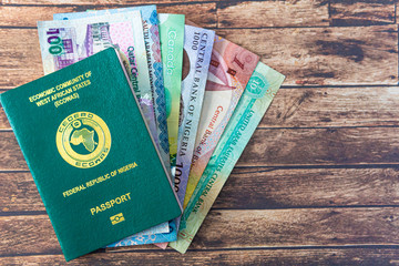 Nigerian Passport with various currencies - obrazy, fototapety, plakaty