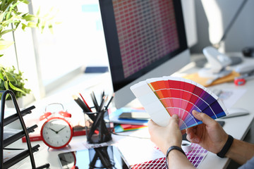 Male serviceman hold in hand fantail making colour test at worktable