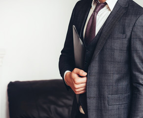 successful businessman with clipboard standing in the hall of the business center