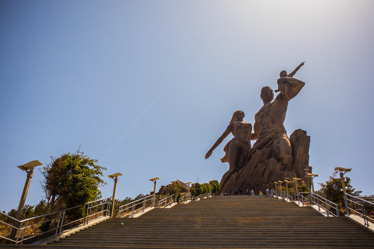 The statue of african renaissance or "monument de la renaissance africaine" on a sunny february day in Dakar, Senegal. View from the bottom of the stairs leading up.