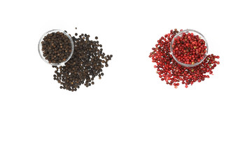 Colorful red and black peppercorns on white background