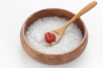 Japanese  food, Umeboshi and healthy rice congee in wooden bowl
